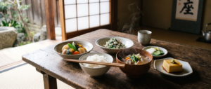 "Traditional shojin ryori Buddhist temple meal featuring ichiju sansai format with white rice, kenchinjiru soup, seasonal vegetable side dishes, and gomadofu sesame tofu, arranged on simple pottery in contemplative temple setting with natural light."